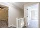 Hallway with carpeted stairs and open doorways leading to bedrooms at 557 Old Friar Tuck Ln, Stone Mountain, GA 30087