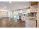 Well-lit kitchen with granite countertops, white cabinets, and a seamless flow to the dining area at 557 Old Friar Tuck Ln, Stone Mountain, GA 30087