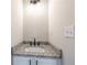 Close-up of powder room vanity with gray granite countertop and dark hardware at 557 Old Friar Tuck Ln, Stone Mountain, GA 30087