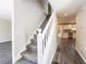 Bright, carpeted staircase with white railing, connecting to the home's upstairs living spaces at 557 Old Friar Tuck Ln, Stone Mountain, GA 30087