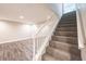 Finished basement staircase leading to a spacious room with modern flooring at 557 Old Friar Tuck Ln, Stone Mountain, GA 30087