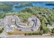 Aerial view of a lake community featuring clustered homes and a community pool at 2020 Manor Pointe Dr, Cumming, GA 30041