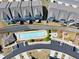 Aerial view showcases community pool, parking, fire pit, and playground surrounded by townhome residences at 2020 Manor Pointe Dr, Cumming, GA 30041