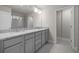 Elegant bathroom featuring a double sink vanity, granite countertops, and tiled floor at 2020 Manor Pointe Dr, Cumming, GA 30041
