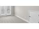 Bedroom features neutral carpet, a ceiling light, and double doors to a private patio at 2020 Manor Pointe Dr, Cumming, GA 30041