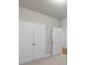 Bedroom offering neutral walls, carpet, and a double door closet for storage at 2020 Manor Pointe Dr, Cumming, GA 30041