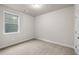Simple bedroom with neutral carpet, a window, and a door at 2020 Manor Pointe Dr, Cumming, GA 30041