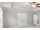 Bedroom boasts trey ceiling, neutral walls, carpet, ceiling fan, and a double door closet at 2020 Manor Pointe Dr, Cumming, GA 30041