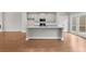Kitchen island with granite countertops and stainless steel appliances, adjoining an open living space at 2020 Manor Pointe Dr, Cumming, GA 30041
