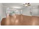 Open-concept living area with hardwood floors, modern lighting, a ceiling fan, and access to other areas at 2020 Manor Pointe Dr, Cumming, GA 30041