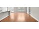 Spacious room featuring beautiful hardwood floors, with kitchen access and an abundance of natural light throughout the space at 2020 Manor Pointe Dr, Cumming, GA 30041