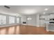 Bright living area featuring hardwood floors, neutral walls, and an open layout connecting the living space to the kitchen at 2020 Manor Pointe Dr, Cumming, GA 30041
