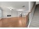 Spacious living room with hardwood floors, a fireplace, and staircase leading to the upper level at 2020 Manor Pointe Dr, Cumming, GA 30041