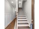 Staircase with wood railings leading to the upper level of a modern home at 2020 Manor Pointe Dr, Cumming, GA 30041