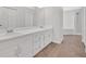 Bathroom featuring double sinks, white cabinets, and a bathtub at 2280 Lansdowne Dr, Canton, GA 30115