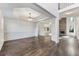 Spacious living room with dark wood floors, decorative trim, and a view to the living room with stone fireplace at 314 Lake Bluff Ct, Suwanee, GA 30024