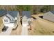 Aerial view of a two-story home with a driveway, manicured lawn, and wooden fence at 375 Milton Dr, Covington, GA 30016