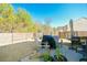 Cozy backyard patio featuring a privacy fence, outdoor furniture, and a grill, perfect for outdoor entertaining at 375 Milton Dr, Covington, GA 30016