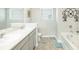 Spacious bathroom with double sinks, soaking tub, neutral color palette, and good natural light from a large window at 375 Milton Dr, Covington, GA 30016