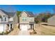 Charming two-story home featuring a well-manicured lawn, single-car garage and neutral-colored exterior at 375 Milton Dr, Covington, GA 30016
