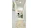 Hallway view with a glimpse into the living and dining areas, tile flooring at 375 Milton Dr, Covington, GA 30016