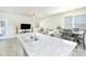 Open-concept kitchen island with a sink, blending living and dining areas at 375 Milton Dr, Covington, GA 30016