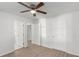 Bedroom featuring light-colored wood look floors, a ceiling fan, and doors to other rooms at 7155 Pineneedle Drive Sw, Covington, GA 30016