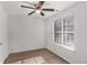 Bedroom featuring a ceiling fan, a window letting in natural light, and light-colored wood look floors at 7155 Pineneedle Drive Sw, Covington, GA 30016