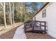 Side view of a white home featuring vinyl siding, a deck, and a walkway at 7155 Pineneedle Drive Sw, Covington, GA 30016