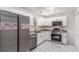 Well-equipped kitchen featuring stainless steel appliances, granite countertops, and white cabinetry at 7155 Pineneedle Drive Sw, Covington, GA 30016