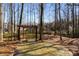 Backyard seating area with shade providing pergola and mature trees at 825 Autry Landing Cir, Alpharetta, GA 30022