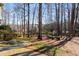 Spacious backyard featuring a wooded area with walking paths at 825 Autry Landing Cir, Alpharetta, GA 30022