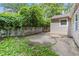 Backyard patio area beside the house featuring a concrete block wall and vegetation at 2825 3Rd Sw Ave, Atlanta, GA 30315