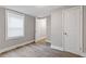 Bright bedroom featuring hardwood floors, neutral paint, a large window, and closet space at 2825 3Rd Sw Ave, Atlanta, GA 30315
