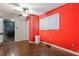 A bedroom showcases dark wood floors, red walls, a ceiling fan and natural light from the windows at 2825 3Rd Sw Ave, Atlanta, GA 30315