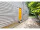 Exterior view shows side of home with siding, bright yellow door, and concrete walkway to backyard at 2825 3Rd Sw Ave, Atlanta, GA 30315