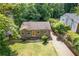 Charming home with green lawn, a driveway, and lush trees providing shade and privacy at 2825 3Rd Sw Ave, Atlanta, GA 30315