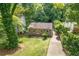 Charming home with green lawn, a driveway, and lush trees providing shade and privacy at 2825 3Rd Sw Ave, Atlanta, GA 30315