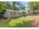 View of a one story home with a green lawn, surrounded by greenery at 2825 3Rd Sw Ave, Atlanta, GA 30315