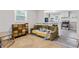 Inviting living room with hardwood floors, a quirky accent table, a large window, and a view into the kitchen at 2825 3Rd Sw Ave, Atlanta, GA 30315