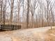Gravel driveway leading to the property, bordered by a wooden fence and bare trees at 1344 Brushy Mountain Rd, Rockmart, GA 30153