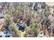 An aerial view of a secluded brick home surrounded by lush trees, offering privacy and a natural setting at 155 Matthew Way, Fayetteville, GA 30214