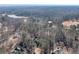 A serene aerial shot of a home nestled in a dense forest, near a lake, providing a tranquil, natural lifestyle at 155 Matthew Way, Fayetteville, GA 30214