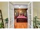 Bedroom view featuring hardwood floors, a four-poster bed, and soft, neutral walls at 155 Matthew Way, Fayetteville, GA 30214