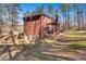 A classic two-story brick home with a walkout basement and a pergola-covered patio in a wooded setting at 155 Matthew Way, Fayetteville, GA 30214