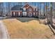 Charming two-story brick home features a well-manicured lawn and classic architectural details at 155 Matthew Way, Fayetteville, GA 30214