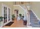 Grand foyer with hardwood floors, staircase, and high ceilings creates a welcoming entrance at 155 Matthew Way, Fayetteville, GA 30214