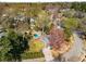 An aerial view showing a pool and yard, with mature trees, and surrounding neighborhood at 166 Erie Ave, Decatur, GA 30030