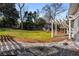 Expansive backyard featuring lush green lawn, playhouse, and decorative landscaping at 166 Erie Ave, Decatur, GA 30030