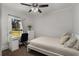 Cozy bedroom with a single bed, desk, and neutral decor by a window at 166 Erie Ave, Decatur, GA 30030